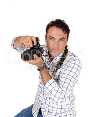 A young man holding his camera ready for a shoot
