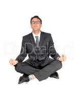Business man sitting on floor doing yoga