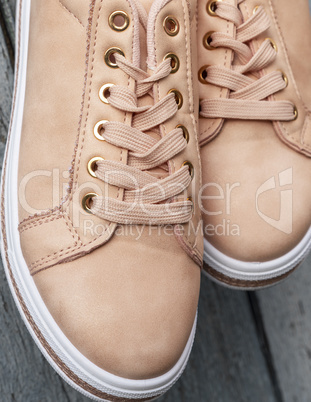 fragment of beige leather women's shoes with laces