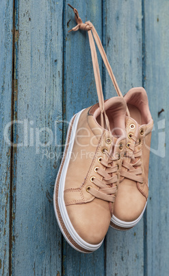 pair of beige fashionable female sports shoes