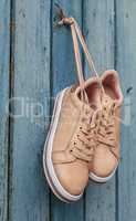 pair of beige fashionable female sports shoes