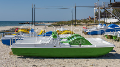 many catamarans on the sandy beach of the sea