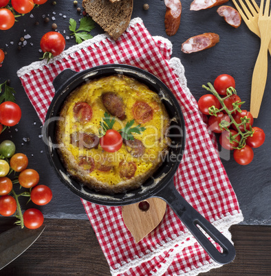 whipped eggs fried in a round black frying pan