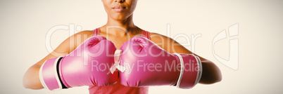 Woman for breast cancer awareness with ribbon in boxing gloves