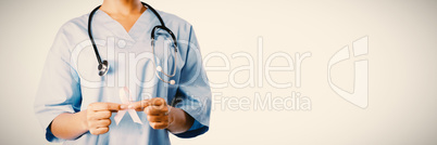 Nurse holding breast cancer awareness pink ribbon with both hands