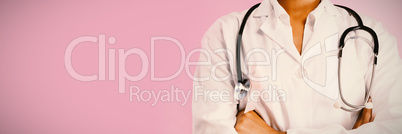 arms crossed nurse wearing breast cancer pink ribbon