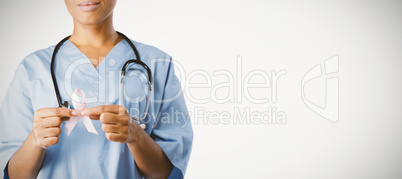 Nurse holding pink ribbon with both hands