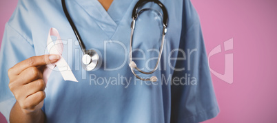 Nurse holding breast cancer awareness pink ribbon