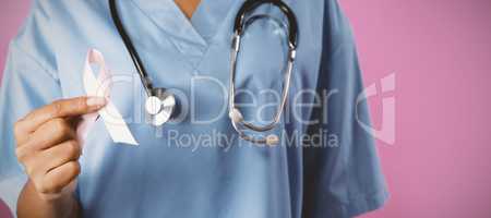 Nurse holding breast cancer awareness pink ribbon