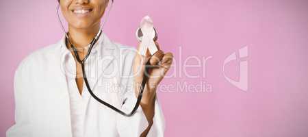 Smiling nurse holding pink ribbon breast cancer awareness