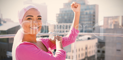 Strong woman in city with breast cancer awareness