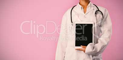 Nurse wearing pink ribbon holding a tablet in her hand