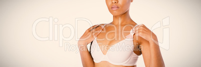 Focused woman for breast cancer awareness with ribbon Focused woman for breast cancer awareness with ribbon