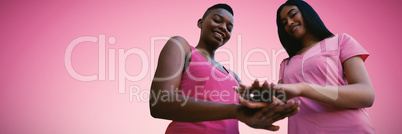 Composite image of two black women joining hands