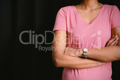 women in pink for breast cancer focus on crossed arms