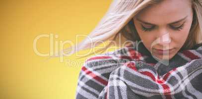 Composite image of close up of a woman wraped in a blanket