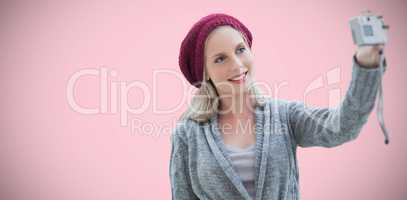 Composite image of woman taking selfie