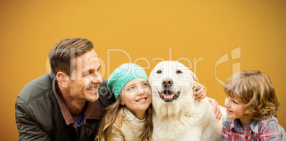 Composite image of  happy family enjoying with dog in leaves
