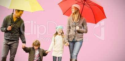 Composite image of  smiling young family under umbrella