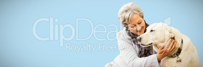 Composite image of senior woman holding a dog