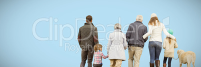 Composite image of happy family walking with their dog