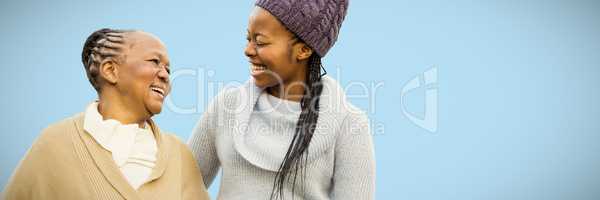 Composite image of mother and grandmother smiling to each other