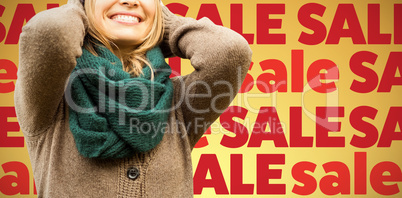 Composite image of  beautiful blond woman with cap and scarf smiling