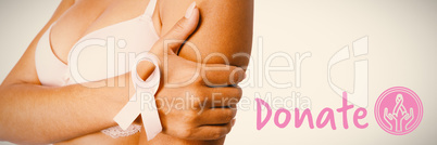 Composite image of graphic image of donate text with breast cancer awareness ribbon