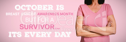 Composite image of  women in pink for breast cancer focus on crossed arms