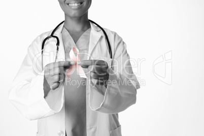 Smiling female doctor holding breast cancer awareness pink ribbon