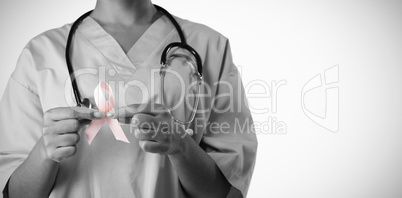 Nurse holding pink ribbon with both hands