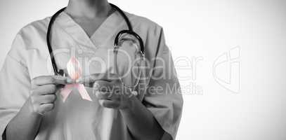 Nurse holding pink ribbon with both hands