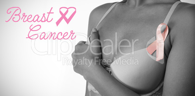 Composite image of breast cancer text with ribbon