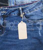 blue jeans with a brown paper empty tag on a rope