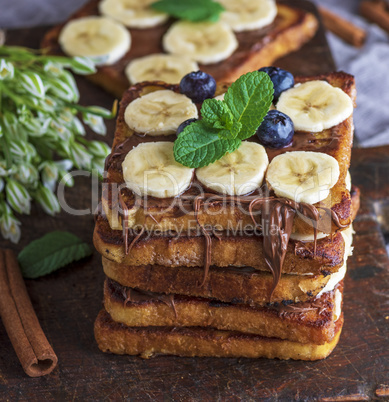 fried chocolate French toasts with pieces of bananas