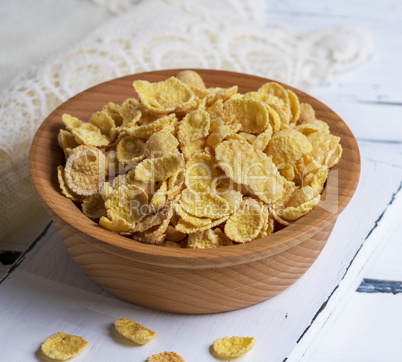 cornflakes in a brown wooden bowl