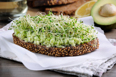 Sandwich with avocado and alfalfa sprouts