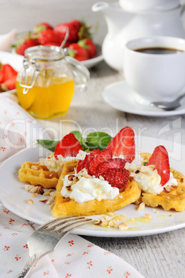 Belgian waffles with whipped cream and strawberries