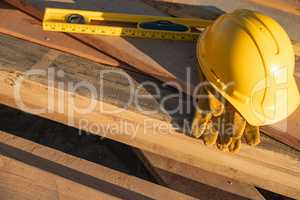 Abstract of Constrcution Hard Hat, Gloves and Level Resting on W