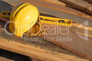 Abstract of Constrcution Hard Hat, Gloves and Level Resting on W
