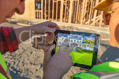 Male and Female Construction Workers Reviewing House on Computer