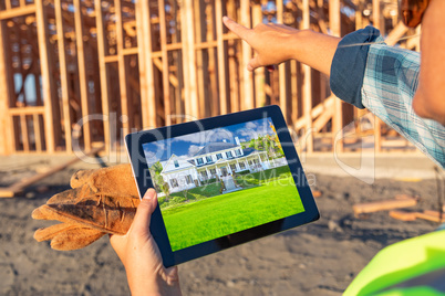 Female Construction Worker Reviewing House Photo on Computer Pad