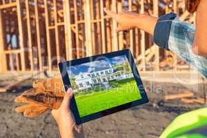 Female Construction Worker Reviewing House Photo on Computer Pad