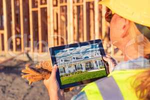 Female Construction Worker Reviewing House Photo on Computer Pad