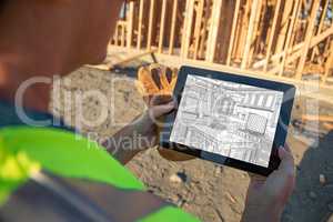 Female Construction Worker Reviewing Kitchen Drawing on Computer