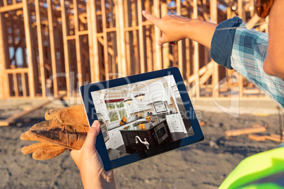 Female Construction Worker Reviewing Kitchen on Computer Pad at