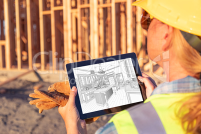 Female Construction Worker Reviewing Kitchen Drawing on Computer