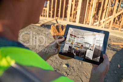 Female Construction Worker Reviewing Kitchen on Computer Pad at