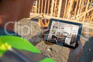 Female Construction Worker Reviewing Kitchen on Computer Pad at