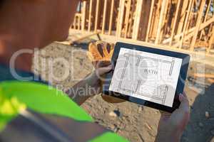 Female Construction Workers Reviewing House Plans on Computer Pa